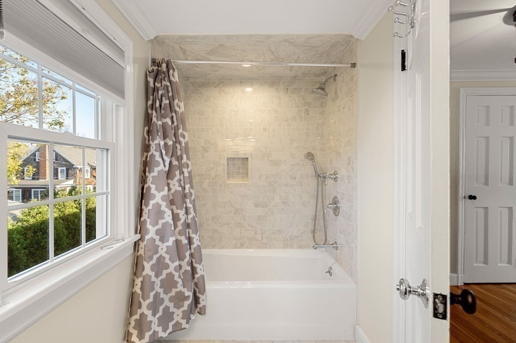 20 Shetland Road Marblehead, MA 01945 - Photo 33 of 40 a bathroom with a shower curtain and a bath tub