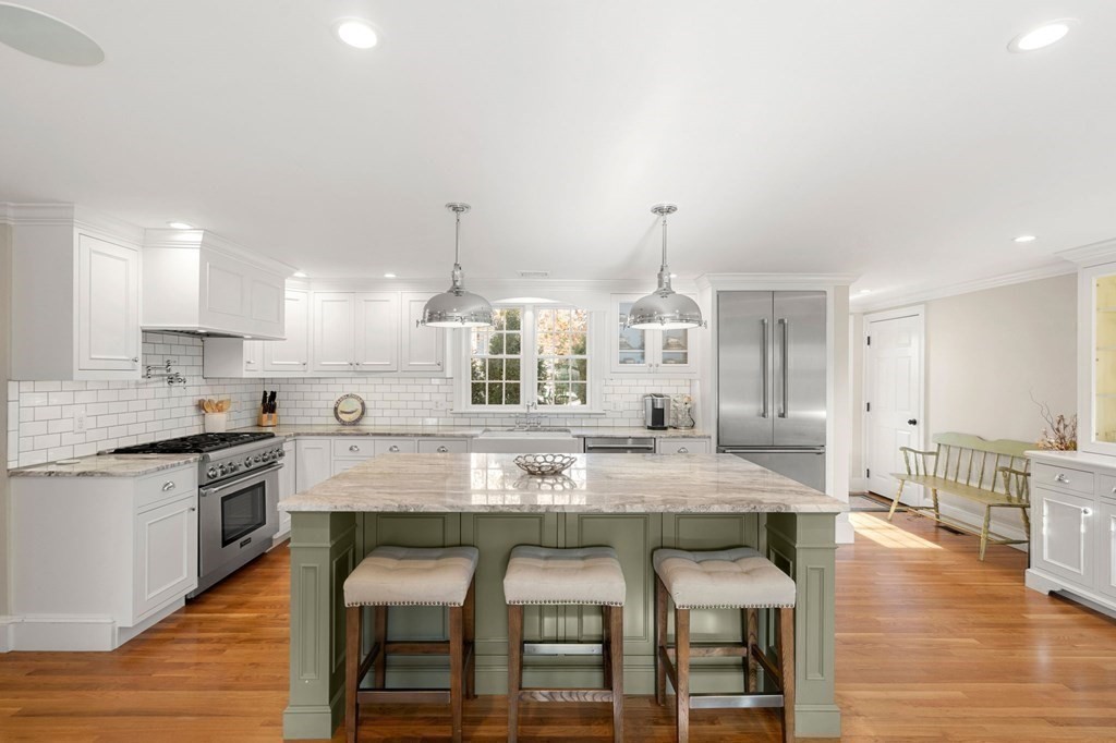20 Shetland Road Marblehead, MA 01945 - Photo 10 of 40 a kitchen with granite countertop a table chairs stove a sink and refrigerator