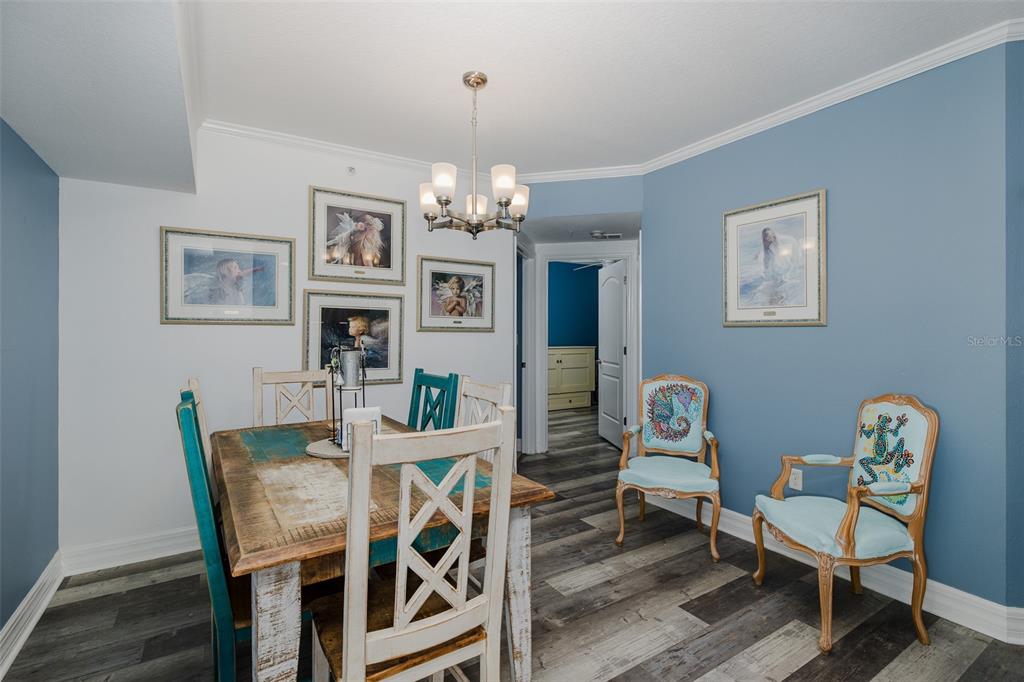 4516 Seagull Drive, Unit 615 New Port Richey, FL 34652 - Photo 11 of 45 a view of a dining room with furniture and chandelier