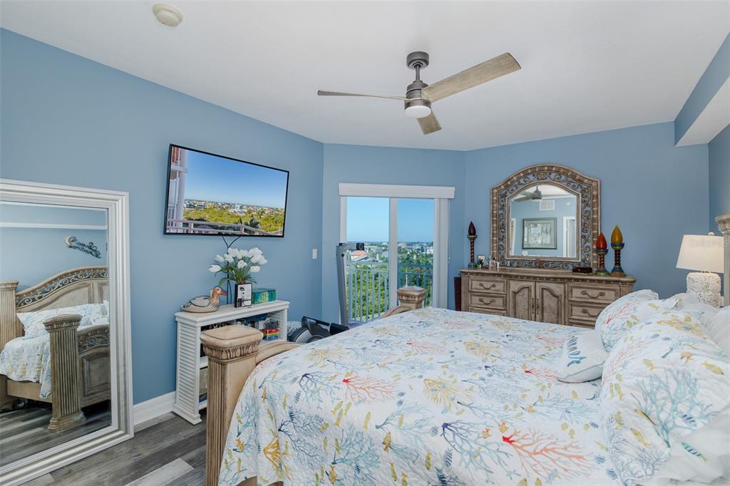 4516 Seagull Drive, Unit 615 New Port Richey, FL 34652 - Photo 14 of 45 a bedroom with a bed a ceiling fan and a dresser