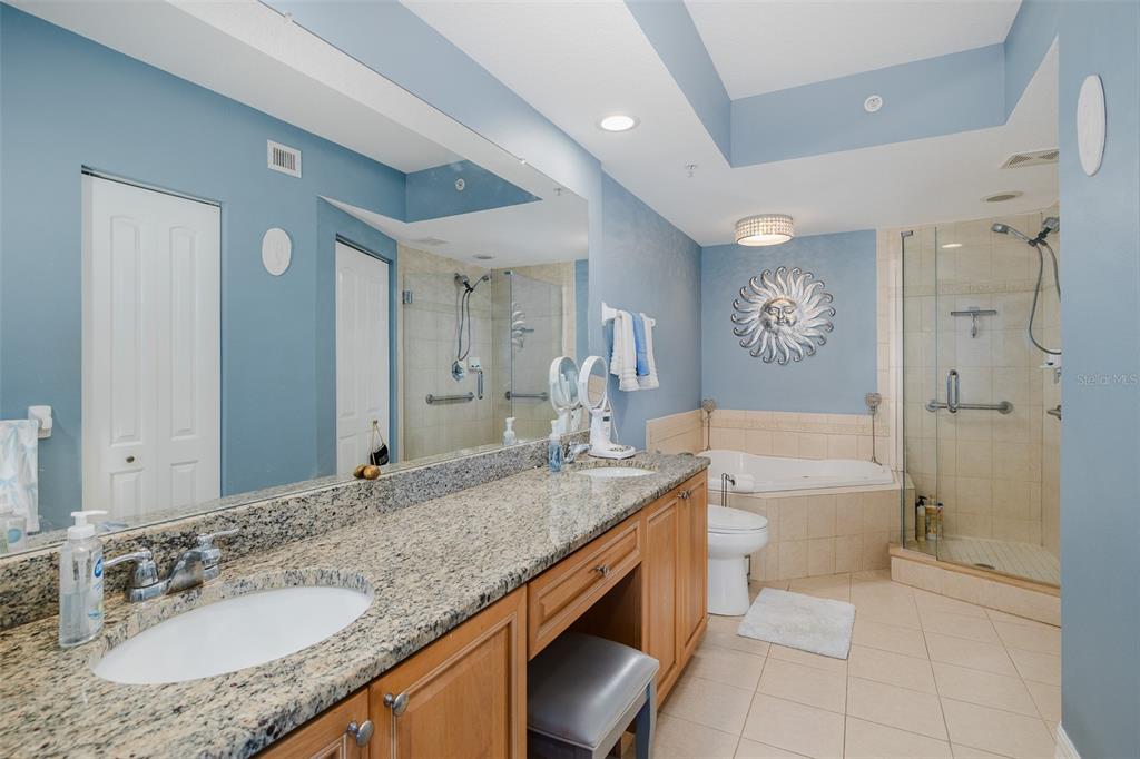 4516 Seagull Drive, Unit 615 New Port Richey, FL 34652 - Photo 15 of 45 a bathroom with a granite countertop sink toilet and shower