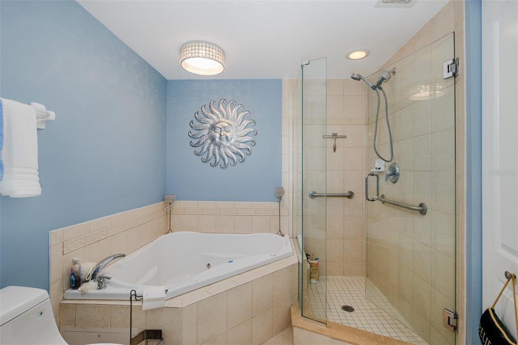 4516 Seagull Drive, Unit 615 New Port Richey, FL 34652 - Photo 16 of 45 a bathroom with a tub and a shower