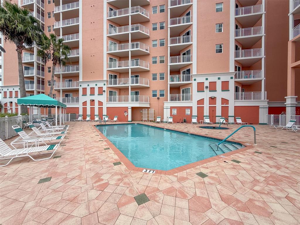 4516 Seagull Drive, Unit 615 New Port Richey, FL 34652 - Photo 38 of 45 a view of a swimming pool with a lounge chairs