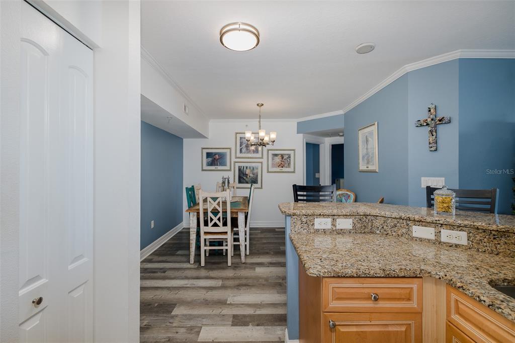 4516 Seagull Drive, Unit 615 New Port Richey, FL 34652 - Photo 10 of 45 a kitchen with kitchen island granite countertop a refrigerator and cabinets