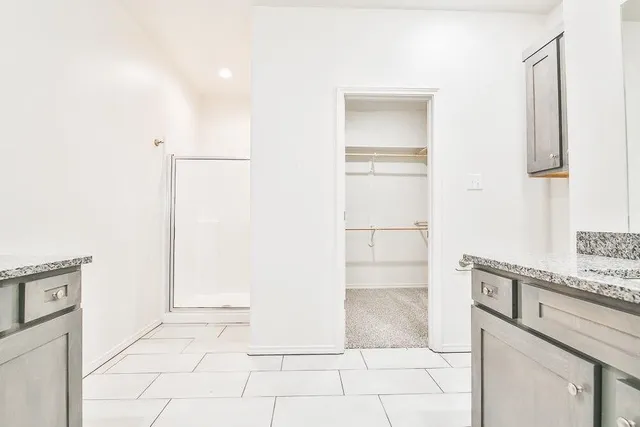 a view of cabinets and utility room with closet