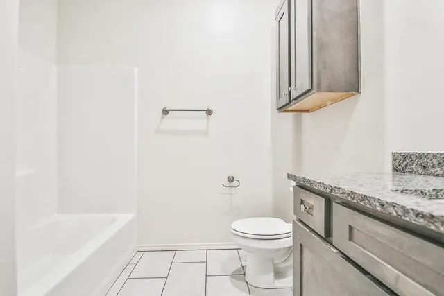 a bathroom with a toilet a sink and bathtub