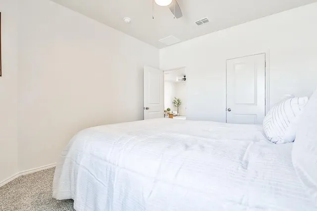 a bedroom with a bed and a night stand