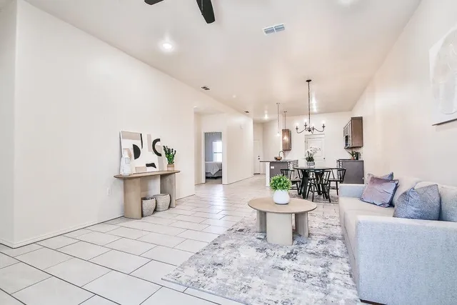 a living room with furniture and a wooden floor