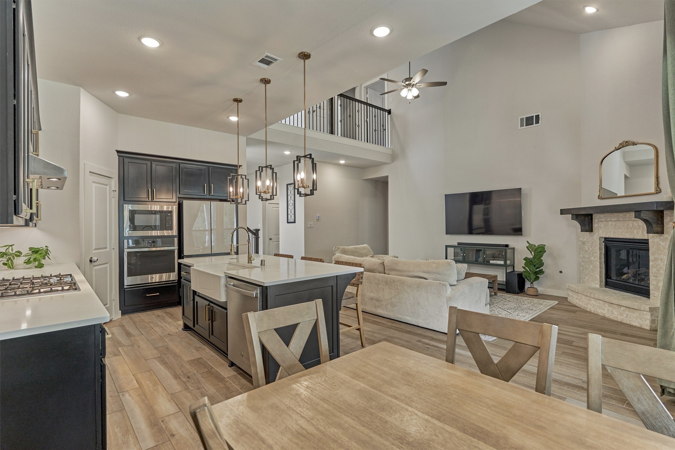 335 Samuels Link Lane Montgomery, TX 77316 - Photo 13 of 45 a living room with stainless steel appliances kitchen island granite countertop furniture a rug kitchen view and a fireplace