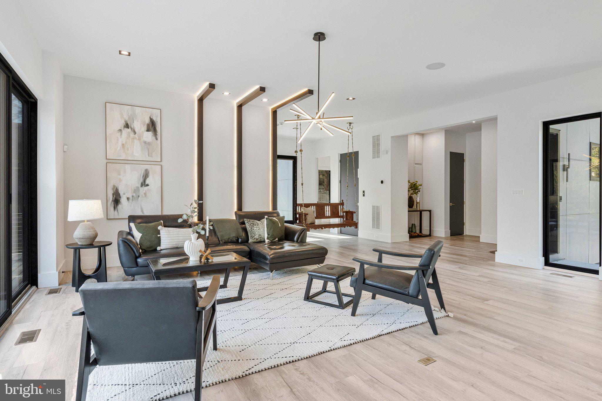 3525 Glenbrook Road Fairfax, VA 22031 - Photo 13 of 111 a living room with couches a large mirror and a dining table with wooden floor