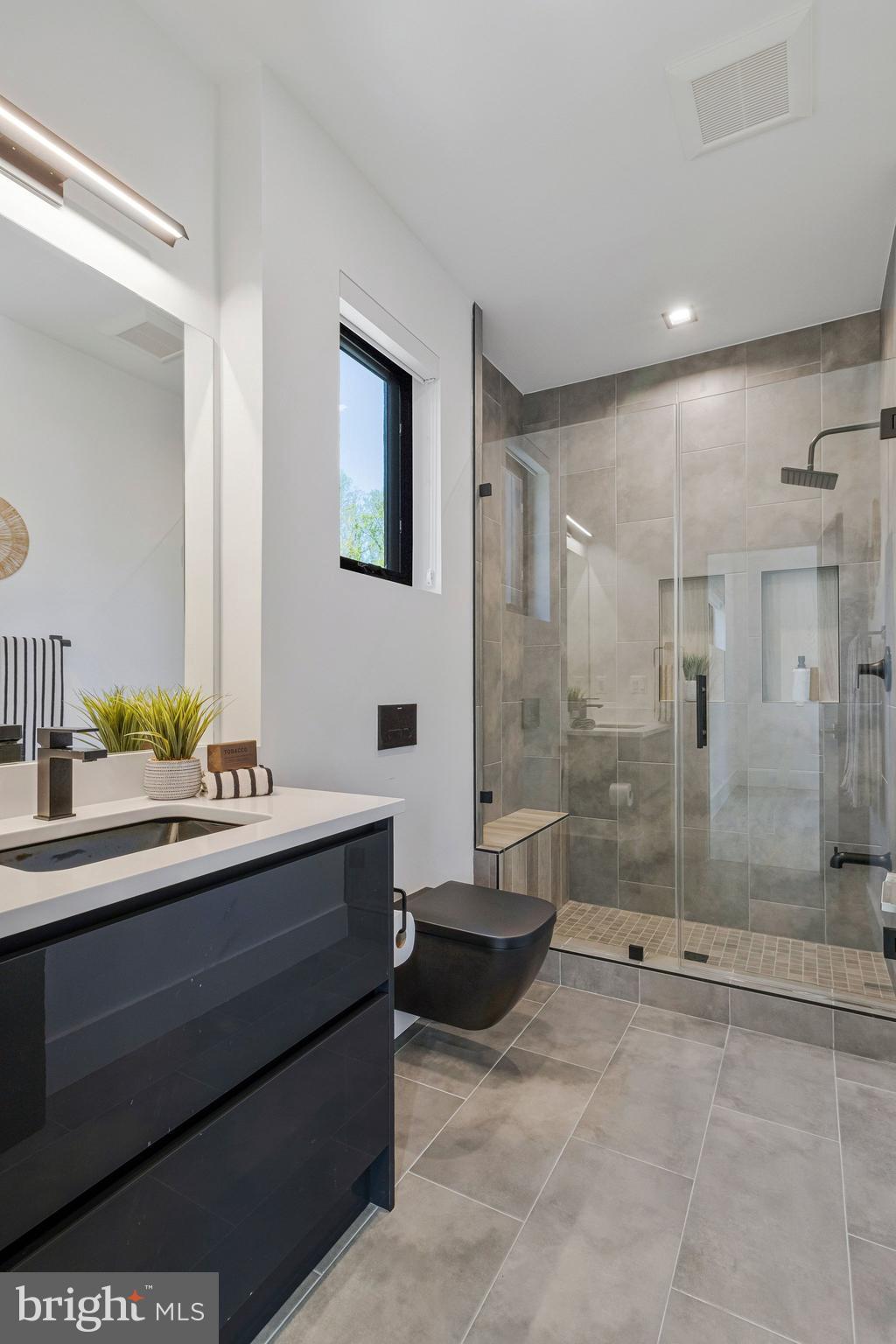 3525 Glenbrook Road Fairfax, VA 22031 - Photo 64 of 111 a bathroom with a shower sink and mirror