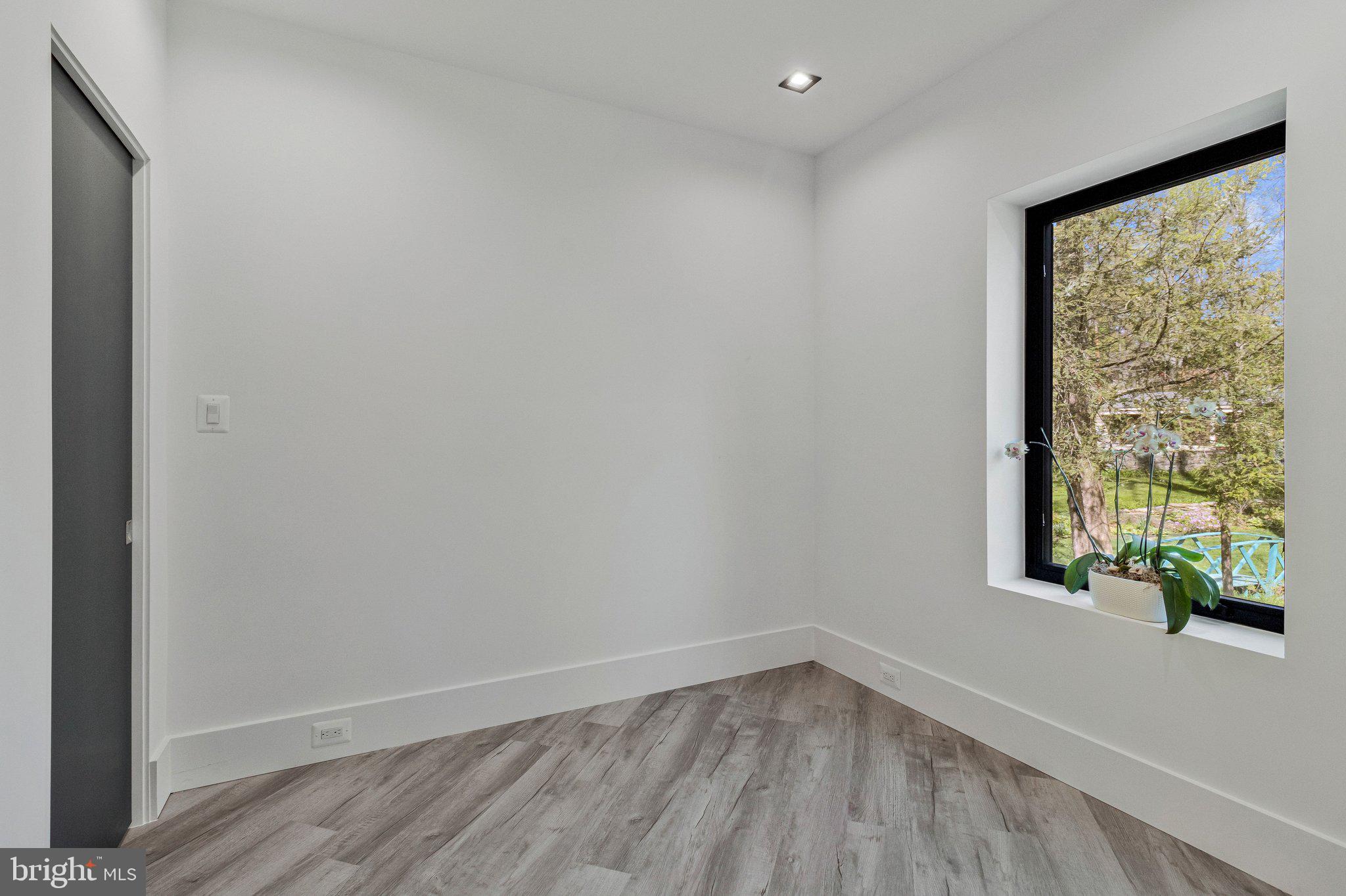 3525 Glenbrook Road Fairfax, VA 22031 - Photo 77 of 111 a view of empty room with wooden floor and fan