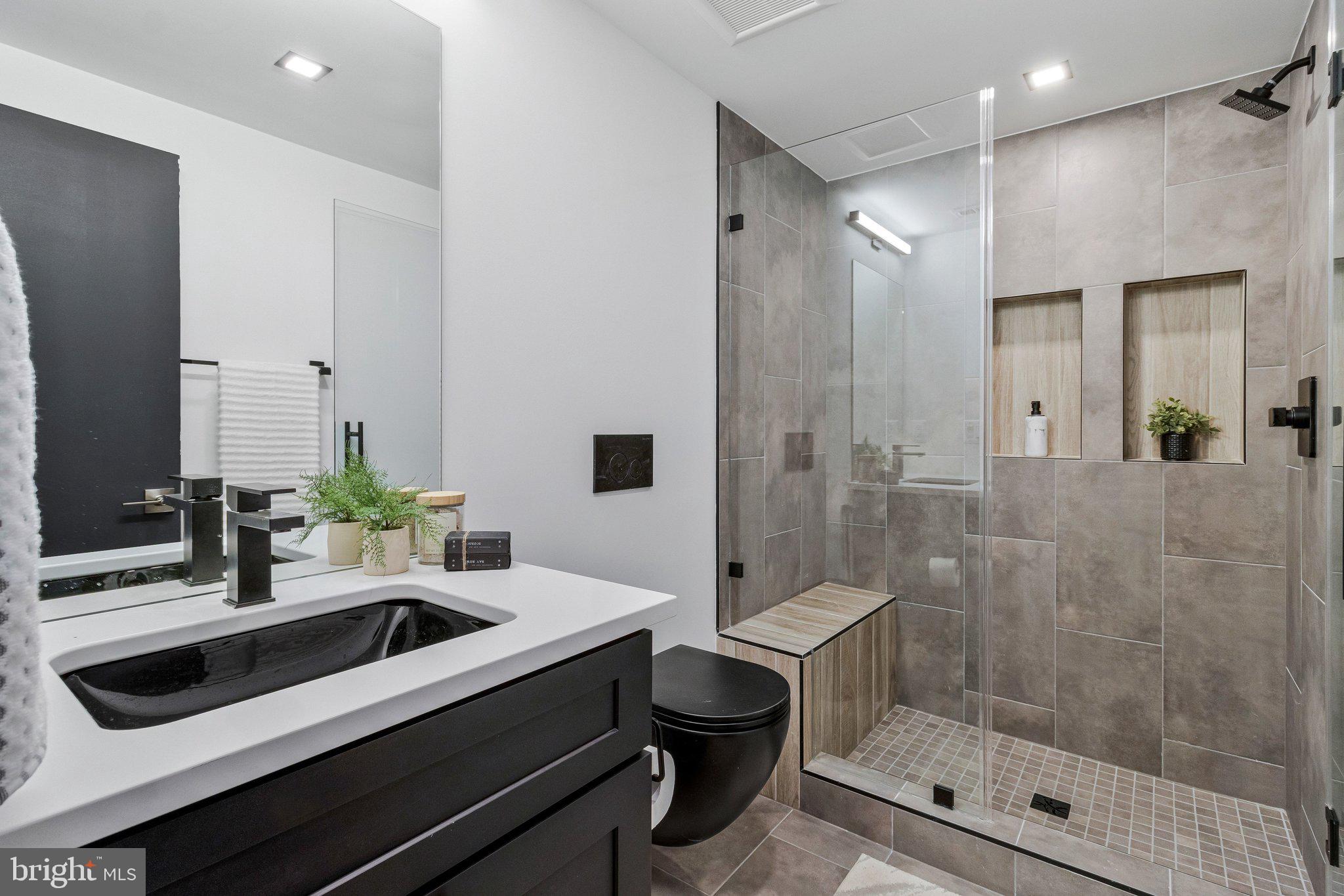 3525 Glenbrook Road Fairfax, VA 22031 - Photo 79 of 111 a bathroom with a sink a toilet and shower