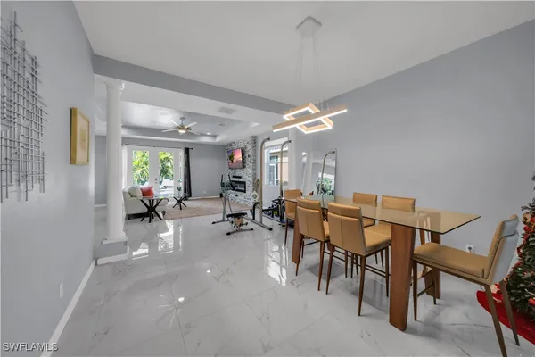 a view of a dining room with furniture and chandelier