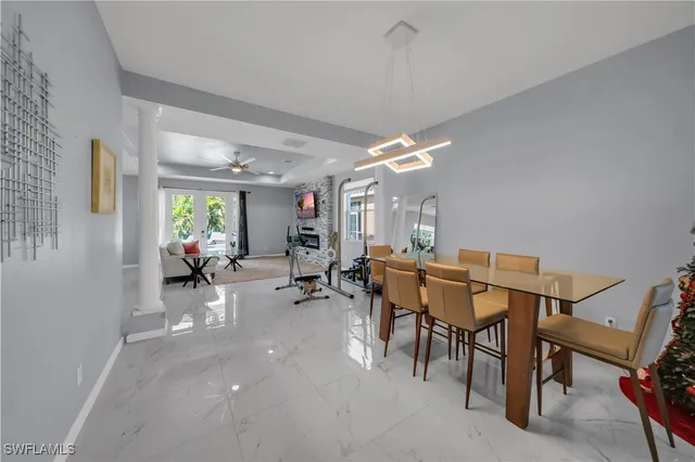 a view of a dining room with furniture and chandelier