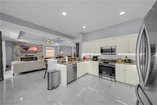 a kitchen with sink a stove and refrigerator