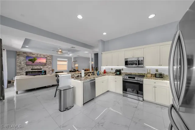 a kitchen with sink a stove and refrigerator