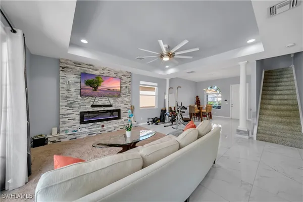 a living room with fireplace furniture and a flat screen tv