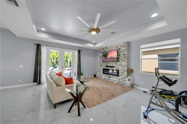 a living room with furniture a flat screen tv and a large window