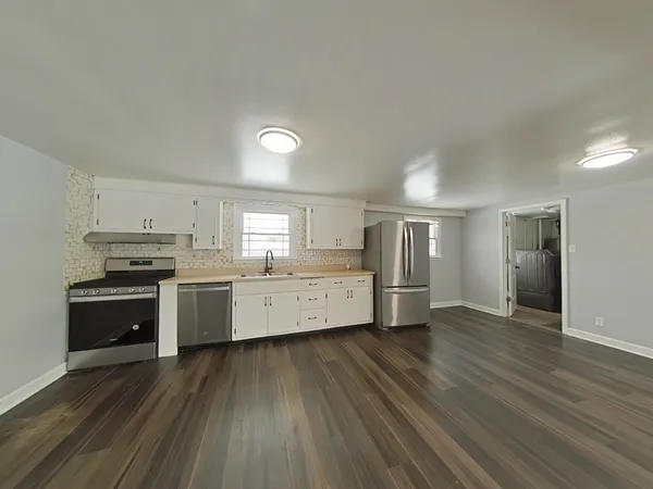 a kitchen with stainless steel appliances a refrigerator and a stove top oven