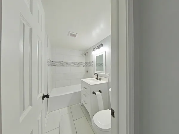 a bathroom with a toilet a sink and bathtub