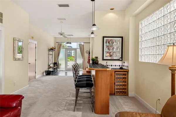 a living room with furniture a desk and chair with wooden floor
