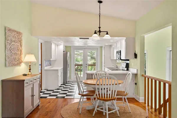 a view of a dining room with furniture window and wooden floor