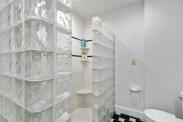 a bathroom with a toilet and a shower