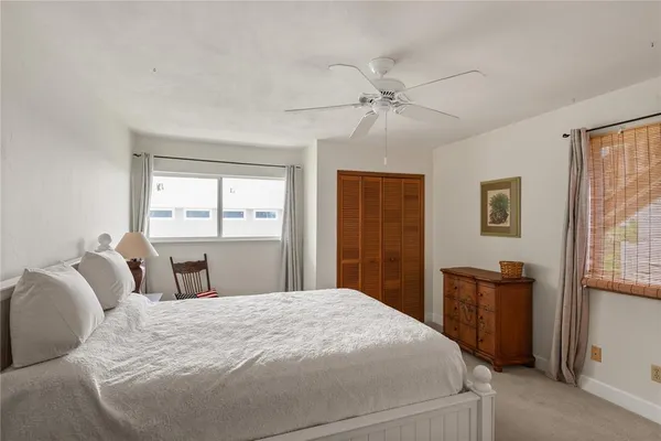 a bedroom with a large bed and a window