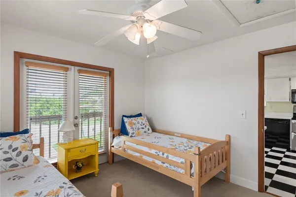 a bedroom with a bed and a window with the dresser