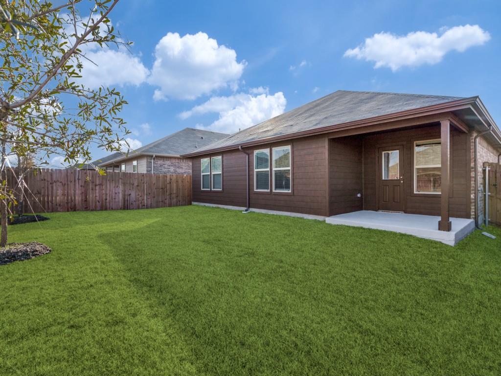 548 Bronze Circle West Springtown, TX 76082 - Photo 11 of 11 Expansive grassy yard with wood fencing, a concrete patio, and a covered porch