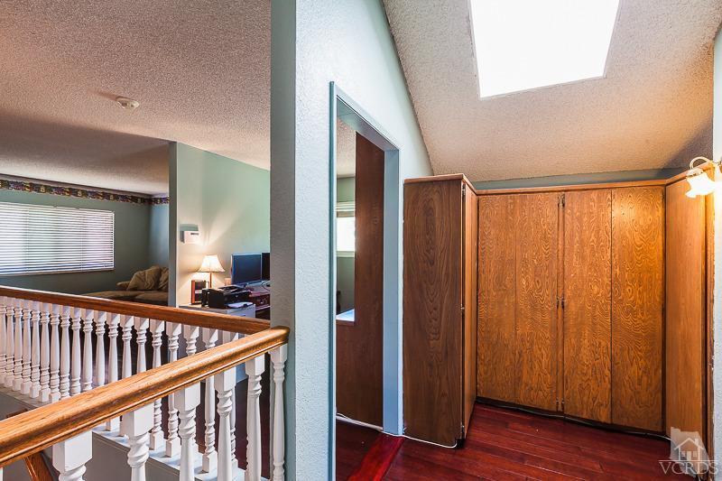 1291 Old Ranch Road Camarillo, CA 93012 - Photo 27 of 41 a view of a hallway with a large window and wooden floor