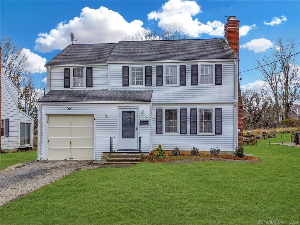 37 Southfield Road Fairfield, CT 06824 - Photo 1 of 1 a front view of a house with a garden
