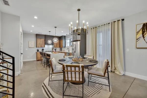 a view of a a dining room with furniture window and wooden floor