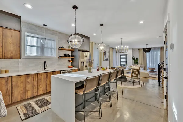 a large kitchen with a table and chairs