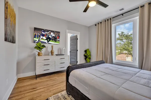 a bedroom with a bed and a chandelier