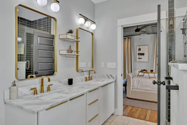 a living room with furniture a chandelier and a wooden floor