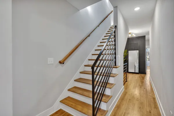 a bathroom with a granite countertop sink a toilet and shower