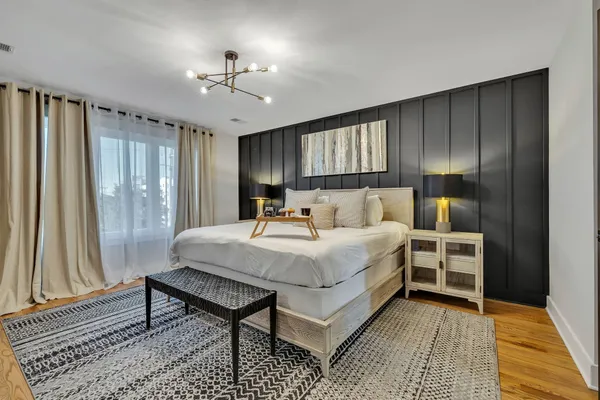 a view of a patio with table and chairs potted plants with wooden floor