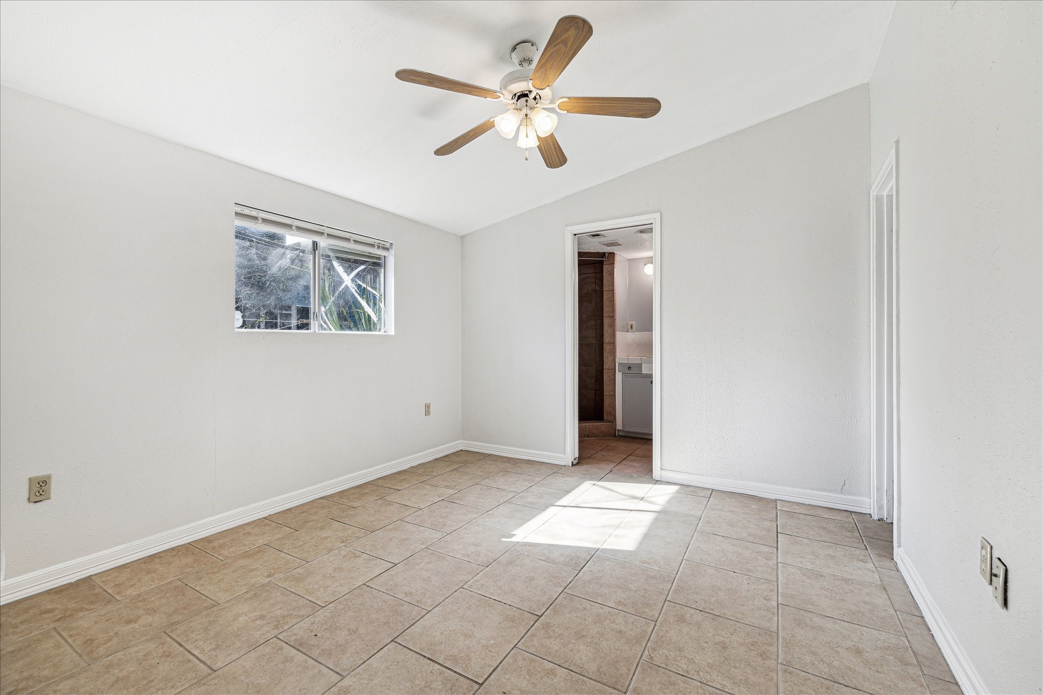 5125 Maple Street Bellaire, TX 77401 - Photo 11 of 14 a view of an empty room with a ceiling fan