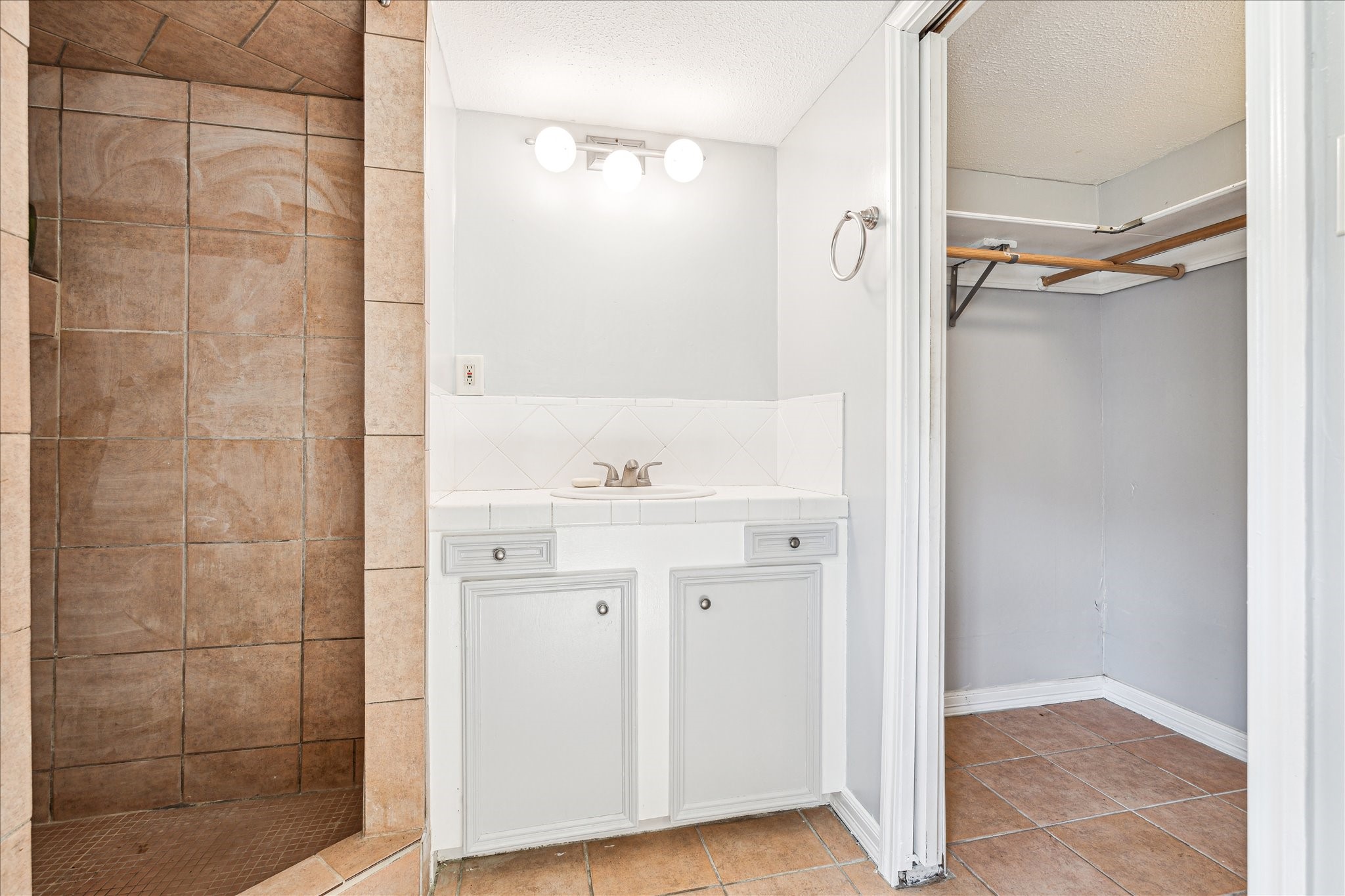 5125 Maple Street Bellaire, TX 77401 - Photo 12 of 14 a bathroom with a sink and a mirror