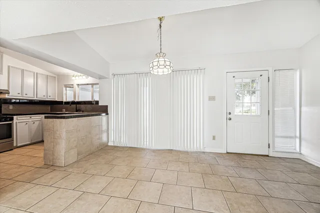 a view of a kitchen with cabinets and stainless steel appliances