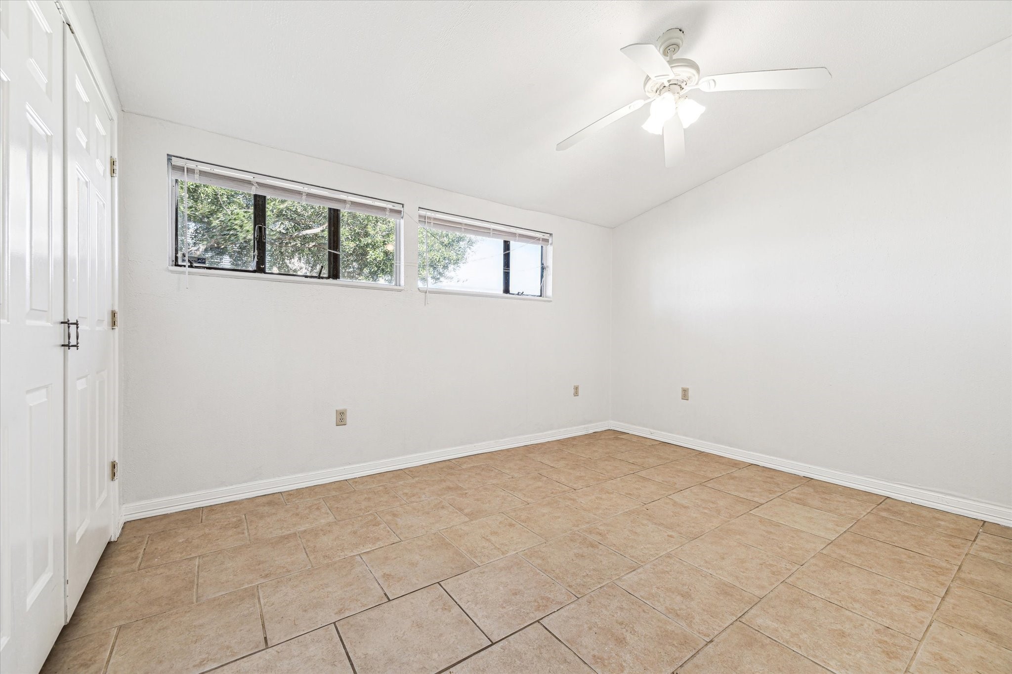 5125 Maple Street Bellaire, TX 77401 - Photo 9 of 14 an empty room with windows and fan