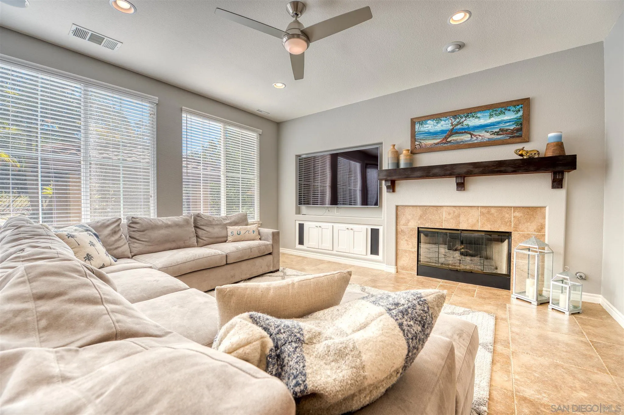 7432 Circulo Sequoia Carlsbad, CA 92009 - Photo 12 of 51 a living room with furniture a fireplace and a flat screen tv