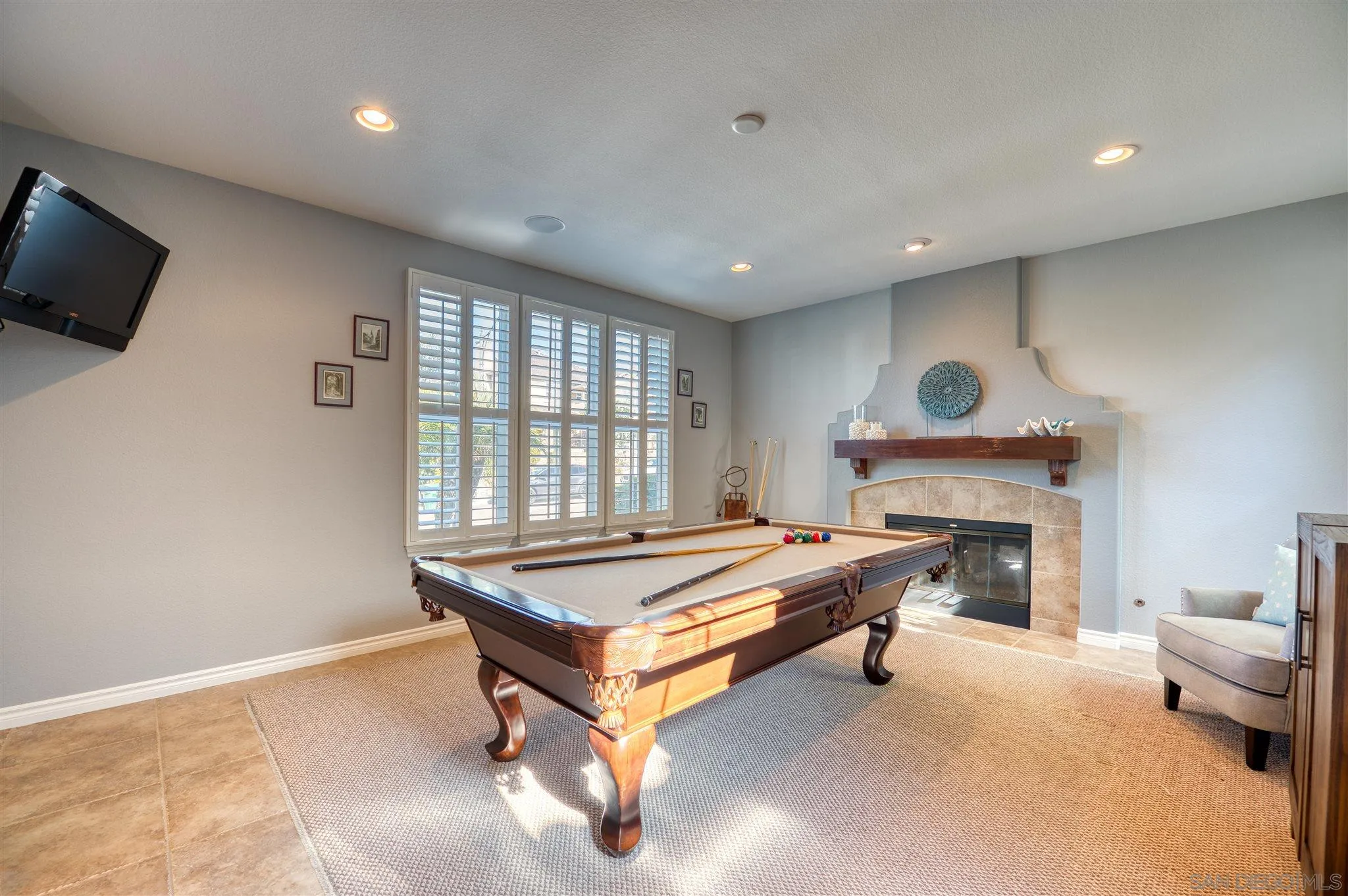 7432 Circulo Sequoia Carlsbad, CA 92009 - Photo 15 of 51 a living room with pool table flat screen tv and windows