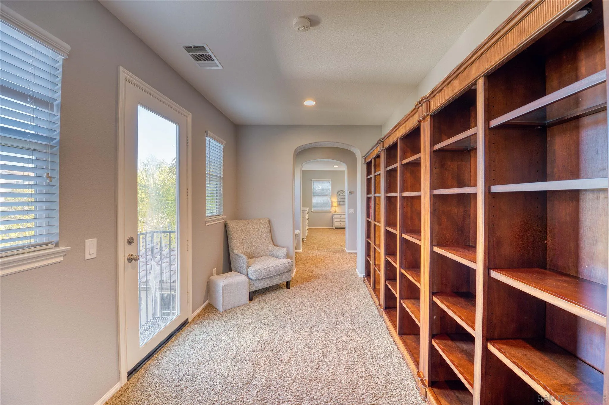 7432 Circulo Sequoia Carlsbad, CA 92009 - Photo 18 of 51 a hallway with couch and a large window