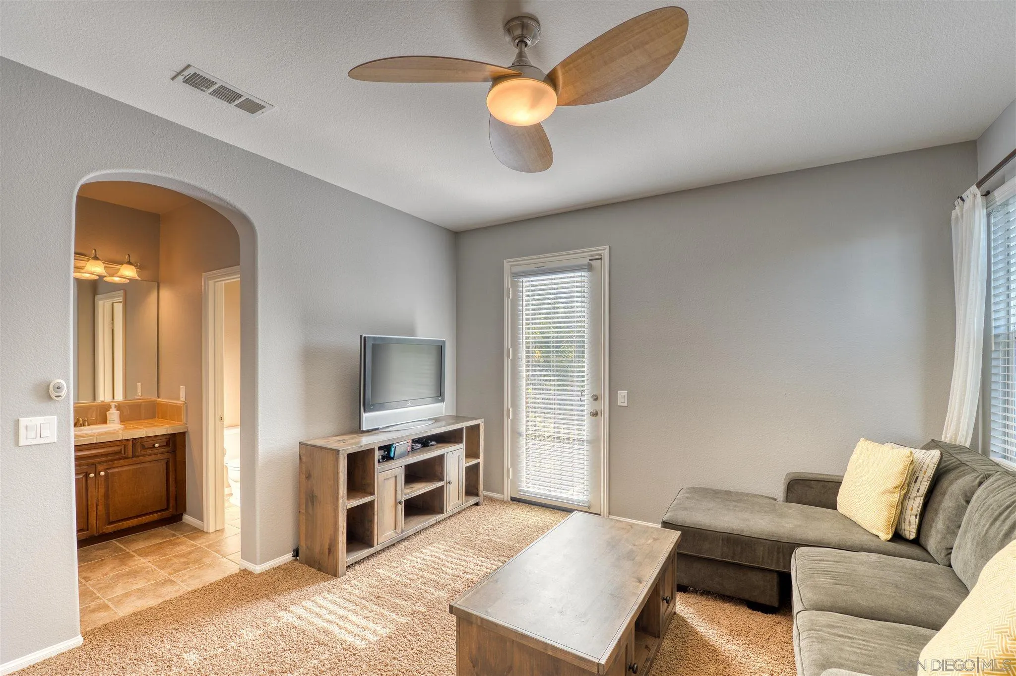 7432 Circulo Sequoia Carlsbad, CA 92009 - Photo 28 of 51 a living room with furniture and a flat screen tv