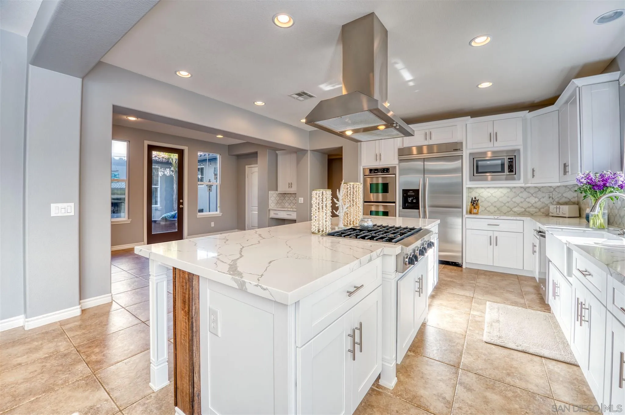 7432 Circulo Sequoia Carlsbad, CA 92009 - Photo 5 of 51 a kitchen with stainless steel appliances kitchen island granite countertop a sink and cabinets