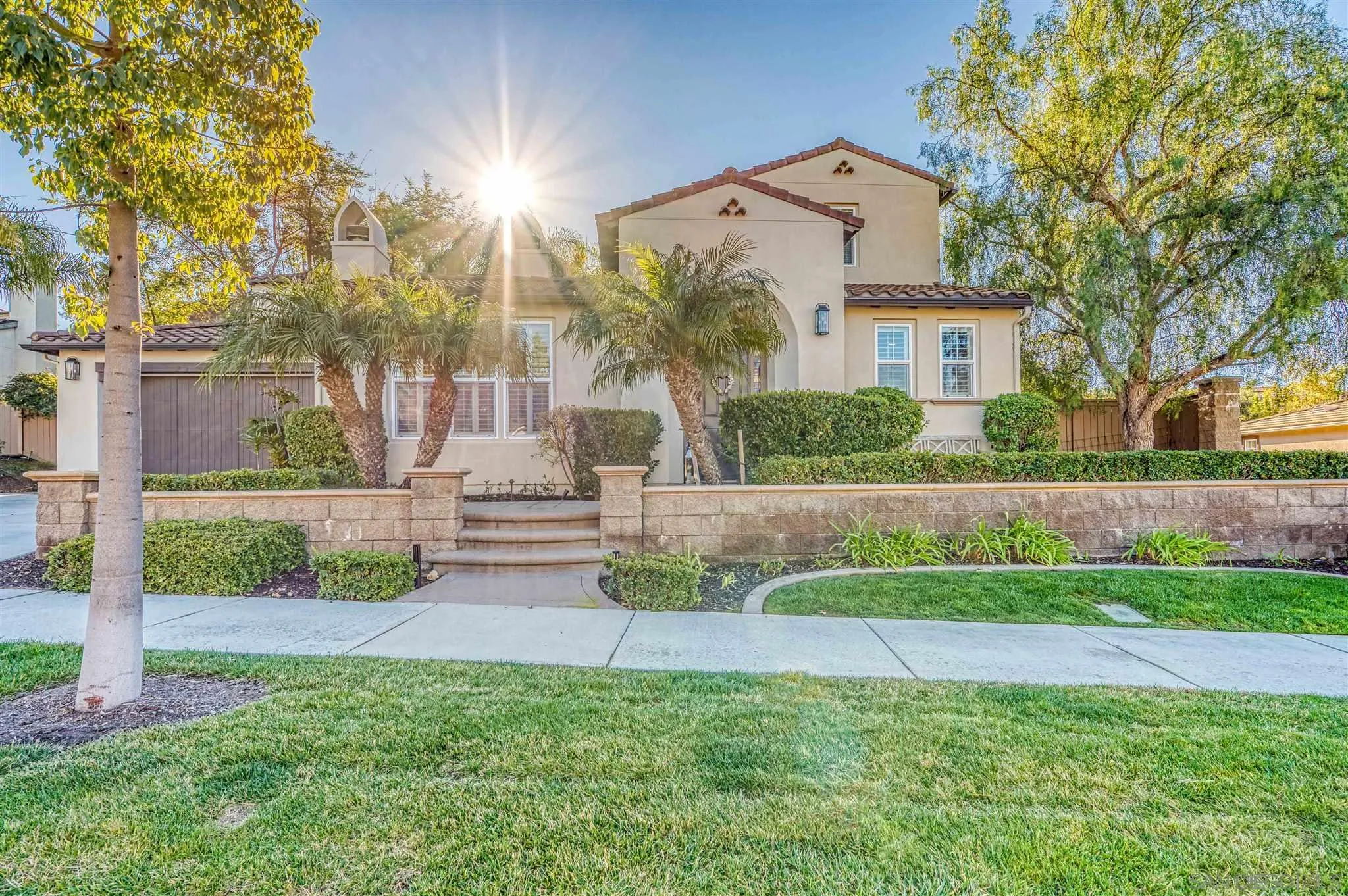 7432 Circulo Sequoia Carlsbad, CA 92009 - Photo 51 of 51 a front view of a house with a yard and garage