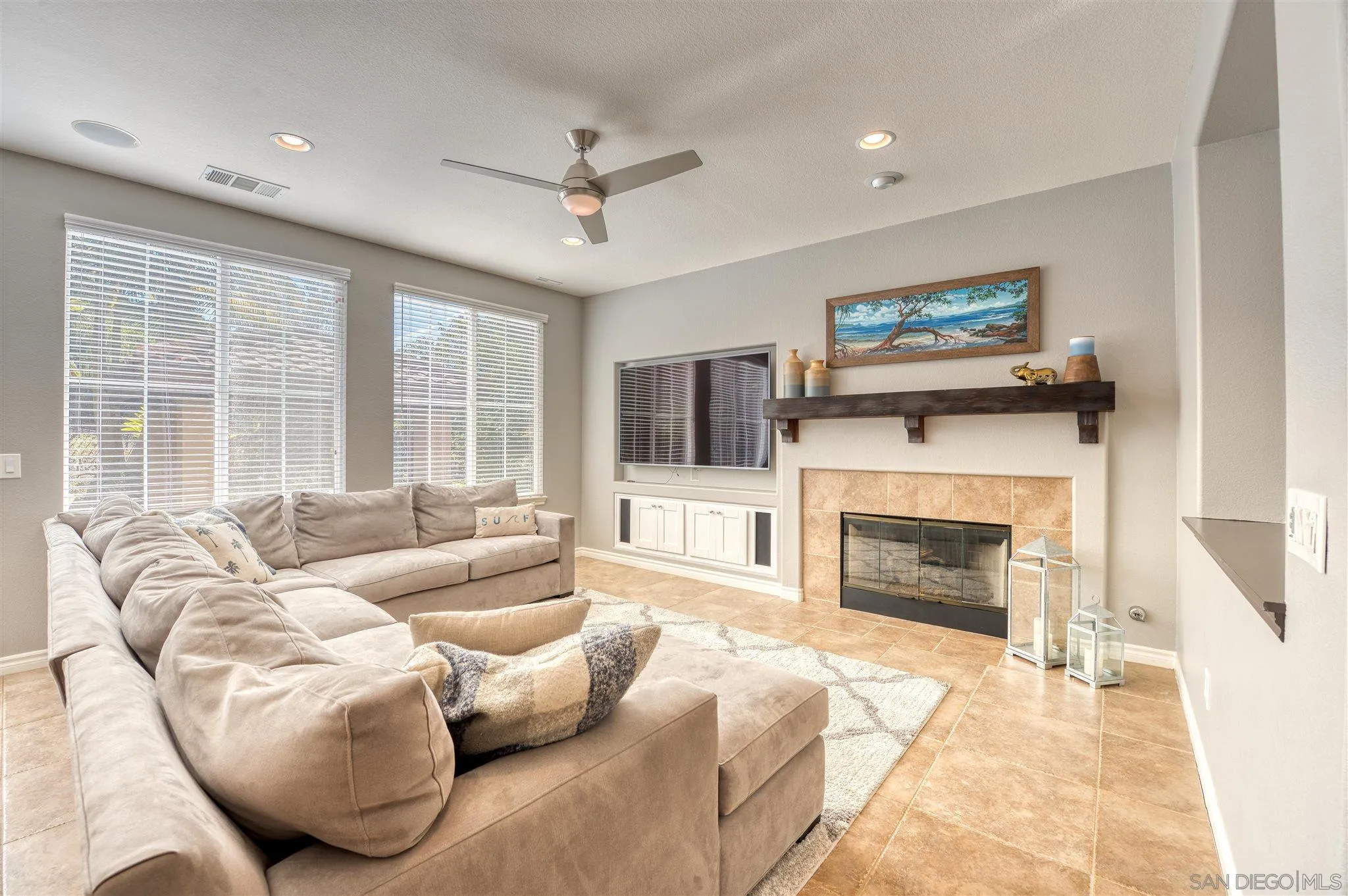 7432 Circulo Sequoia Carlsbad, CA 92009 - Photo 10 of 51 a living room with furniture a flat screen tv and a fireplace
